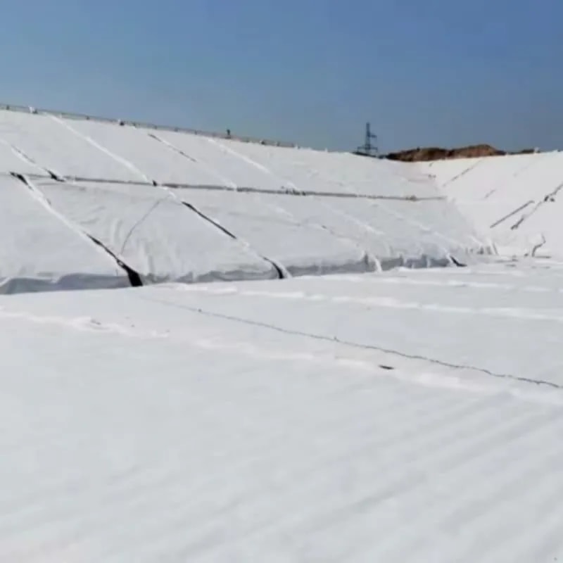 PET geotextile separation and protection layer deployed across a slope
